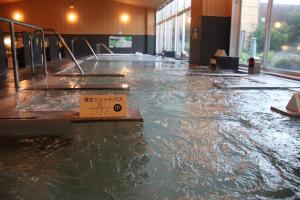 a flooded floor in a building with a sign on it at Castle Inn Toyokawa in Toyokawa