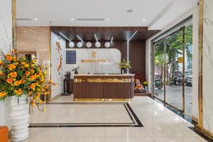 a lobby of a store with a reception desk and flowers at Harmony HaLong Hotel in Ha Long