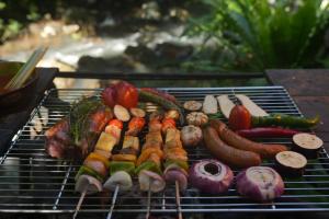 a bunch of different meats and vegetables on a grill at Nampien Yorla Pa in Ban Nôn