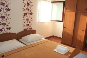 Postel nebo postele na pokoji v ubytování Apartments Petrada