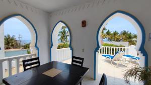 a dining room with arched windows and a table and chairs at Villas Paradise in San Francisco