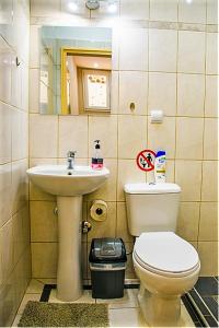 a bathroom with a toilet and a sink at smart Travellers in Thessaloniki