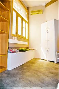 a kitchen with a white refrigerator and a window at smart Travellers in Thessaloniki