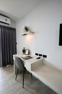 an office with a desk with a chair in a room at Aston Residence Hatyai 