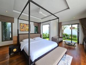 a bedroom with a large bed in a room with windows at Private pool villa 3 Bed, 3 Bath near airport in Phuket +14 photos