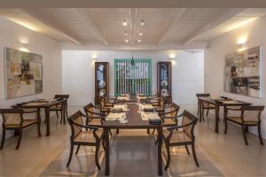 a large dining room with a long table and chairs at Three Gables Boutique Villa in Mirissa