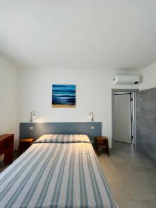a bedroom with a large bed with a painting on the wall at La Ringhiera in Novara