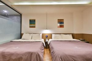 Postel nebo postele na pokoji v ubytování Brown Dot Hotel Jeonggwan