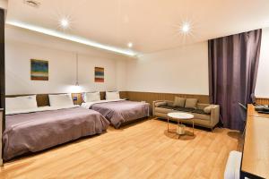 Postel nebo postele na pokoji v ubytování Brown Dot Hotel Jeonggwan