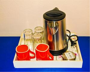 a tray with a coffee pot and cups on a table at smart Travellers in Thessaloniki