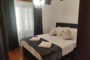 a bedroom with a bed with two towels on it at Kuca za odmor Adriatica in Antovo +58 photos