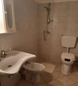 a bathroom with a sink and a toilet and a shower at Agriturismo val martina in Scarlino +28 photos