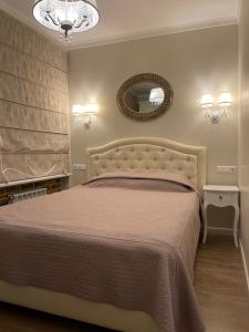 a bedroom with a bed and a mirror on the wall at Vilnius City Walls apartment in Vilnius