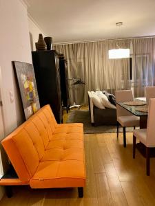 a living room with a couch and a table at Luxury Family suite for 4 in Caxias