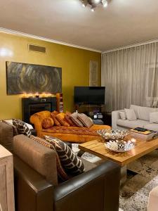 a living room with a couch and a table at Luxury Family suite for 4 in Caxias