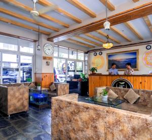a lobby of a restaurant with tables and chairs at Hotel Kunja in Pokhara