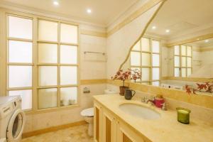 a bathroom with a sink and a toilet and a mirror at Hovevey Tsiyon Luxury Apartment By Nimizz in Jerusalem