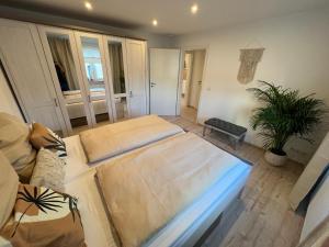 a living room with a large bed and a couch at NAVIA Mira - Design Apartment - Ruhig, Modern & Gemütlich in Dernbach