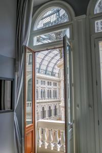 a window with a view of the palace ofminster at Maison San Carlo Luxury Suites in Naples