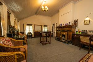 uma sala de estar com mobiliário e uma lareira em Arcadia Heritage Resort em Darjeeling