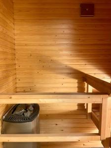 a inside of a sauna with a trash can at Seaside Apartment in Helsinki