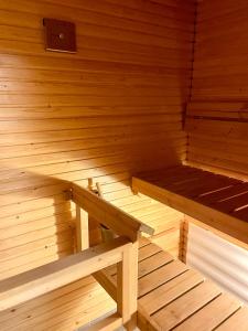 an empty wooden sauna with a bench in it at Seaside Apartment in Helsinki