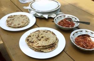 a table with plates of food and bowls of food at Yala Wild Safaris Camp in Tissamaharama