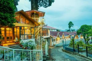 a house with a staircase up to it at Arcadia Heritage Resort in Darjeeling