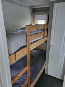 a bunk bed in a tiny house at Chalet Renswouw in Renswoude