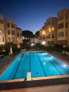 a large swimming pool in front of two buildings at La casetta di Chloè residence con Piscina in Santa Marinella