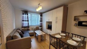 a living room with a couch and a table at Apartament Alek Krosno in Krosno