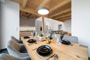 a dining room with a wooden table and chairs at Vánice pod Klínovcem in Loučná pod Klínovcem