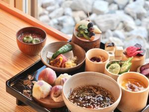 a tray with bowls of food on a table at 禅坊 靖寧 Zenbo Seinei in Awaji