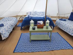 a room with two beds and a table in a tent at Rose in St Austell
