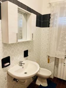 a bathroom with a sink and a toilet at Dream Apartment in Mestre