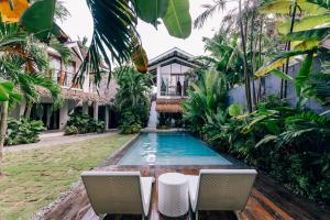 a swimming pool in the yard of a house at Katmon Villas in General Luna