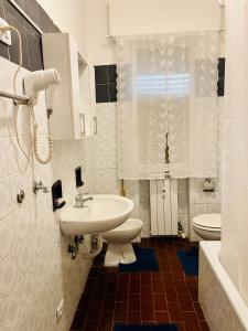 a white bathroom with a sink and a toilet at Dream Apartment in Mestre