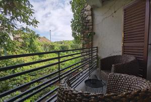 a balcony with two chairs and a table with a view at Luxury Room Uzorita B&B in Šibenik