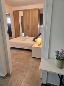 - une chambre avec un lit et une table avec une plante dans l'établissement SC_apartments, à Kato Pyrgos