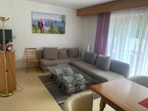 a living room with a couch and a table at enJoy Appartements in Sankt Kanzian