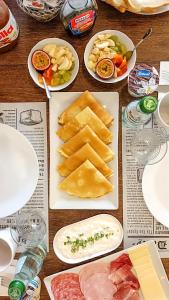 a table topped with different types of food on plates at Moonshine Villa in Nadur