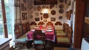 a dining room with a table and plates on the wall at Panka House in Zalakaros