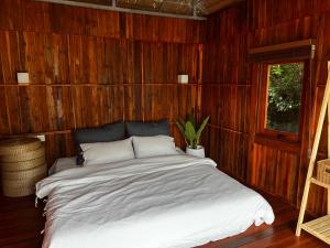 a bedroom with a large bed in a wooden wall at m&r house 