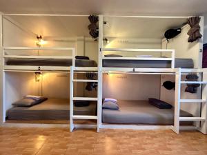 a room with three bunk beds in it at 84 Gallery in Chiang Mai