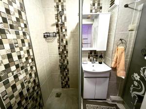 a small bathroom with a sink and a shower at A Nice Place in the City Centre in Meram