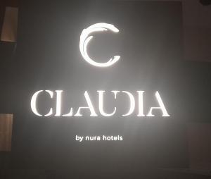 a sign for a drugstore with a c on it at Claudia by Nura in Campos