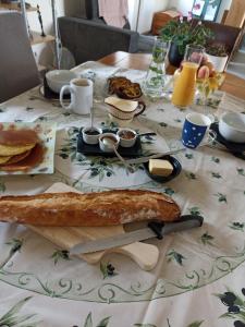 a table with a table cloth with food on it at La Bruyère - B & B - in Tréban