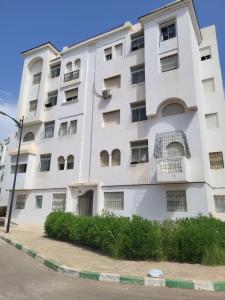 a white apartment building with a lot of windows at complexe doha marjane tetouan in Tétouan