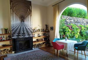 a living room with a fireplace and a table and chairs at Finca El Cardinal - Atemberaubende Luxusvilla in Icod de los Vinos