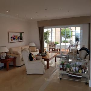 a living room with couches and chairs and a table at Finca El Cardinal - Atemberaubende Luxusvilla in Icod de los Vinos